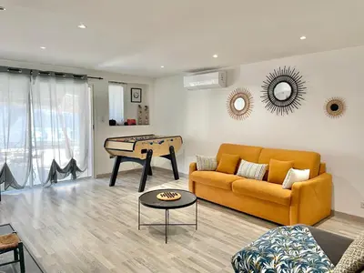 a living room with a couch and a table at Appartement avec piscine 8 personnes in Porto-Vecchio