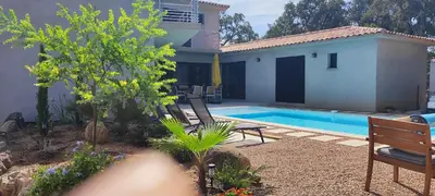 a villa with a swimming pool and a house at Fior di Lucia in Zonza
