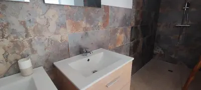 a bathroom with a white sink and a mirror at Fior di Lucia in Zonza