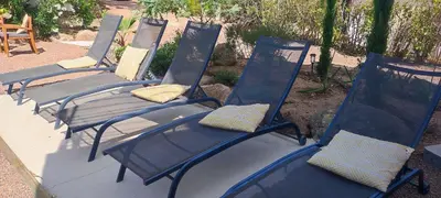 a row of blue chairs with pillows on them at Fior di Lucia in Zonza