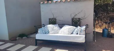 a bed with blue and white pillows on it at Fior di Lucia in Zonza
