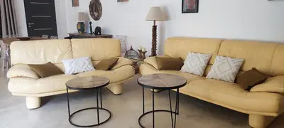 a living room with a couch and two tables at Fior di Lucia in Zonza