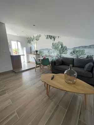 a living room with a couch and a table at Appartement Terrasse in Porto-Vecchio
