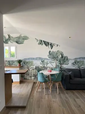 a living room with a table and chairs at Appartement Terrasse in Porto-Vecchio