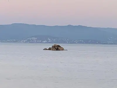 a rock in the middle of the water at Coin de paradis aux Sanguinaires in Ajaccio