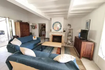 a living room with two blue couches and a fireplace at Ecological house with solar electricity in Ajaccio