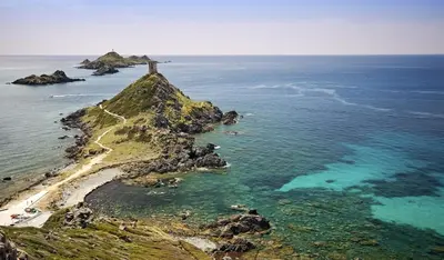 an island in the ocean with a lighthouse on it at L'AZUR des calanques - T2 avec Piscine Chauffée & Vue Mer Exceptionnelle- Parking & Wifi in Ajaccio