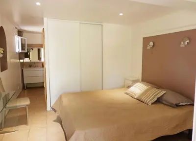 a bedroom with a large bed with two pillows on it at Domaine De Foresta in Bonifacio