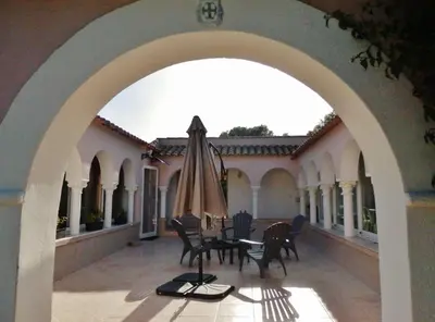 an outdoor patio with a table and an umbrella at Domaine De Foresta in Bonifacio