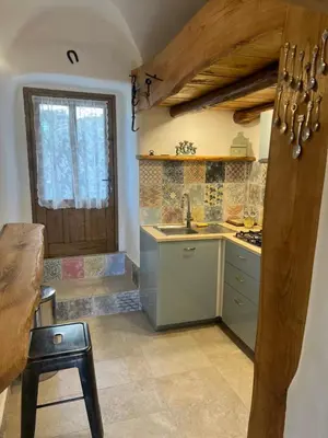 a small kitchen with a sink and a door at Casa Rosa in Gavignano