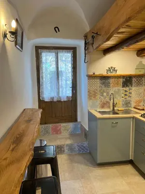 a kitchen with a sink and a wooden door at Casa Rosa in Gavignano