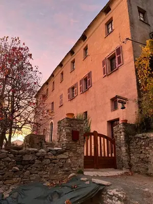 a large brick building with a fence in front of it at Casa Rosa in Gavignano