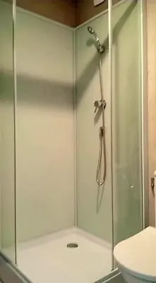 a shower with a glass door in a bathroom at Villa à quelques pas de la plage in Santa-Lucia-di-Moriani