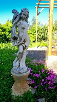 a statue of a little girl holding a child at Villa à quelques pas de la plage in Santa-Lucia-di-Moriani