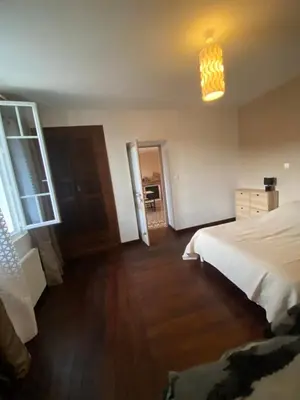 a bedroom with a white bed and a light at Entre montagne et mer in Bastelica