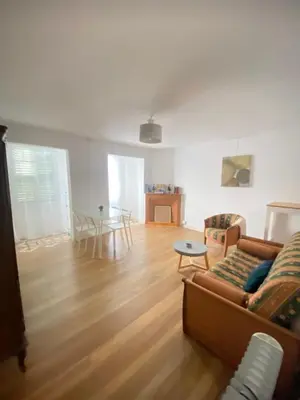 a living room with a couch and a table at Entre montagne et mer in Bastelica
