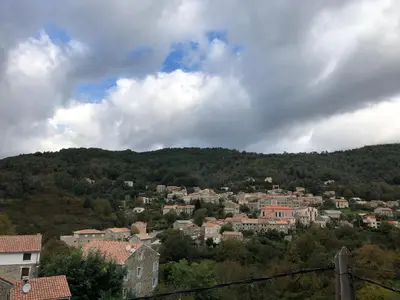 a view of a town on a hill at Entre montagne et mer in Bastelica