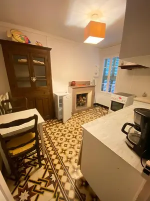 a living room with a fireplace and a table and chairs at Entre montagne et mer in Bastelica