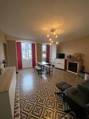 a living room with a couch and a table at Entre montagne et mer in Bastelica
