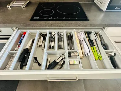 a drawer filled with utensils in a kitchen at Le Deck Porticcio in Grosseto-Prugna