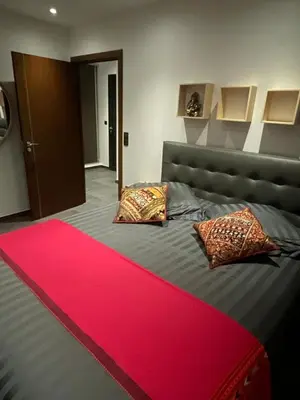 a bedroom with a bed with a red rug on it at Le Deck Porticcio in Grosseto-Prugna