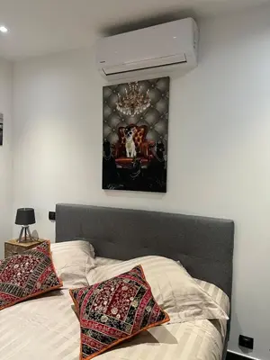 a bedroom with a bed with a chandelier above it at Le Deck Porticcio in Grosseto-Prugna