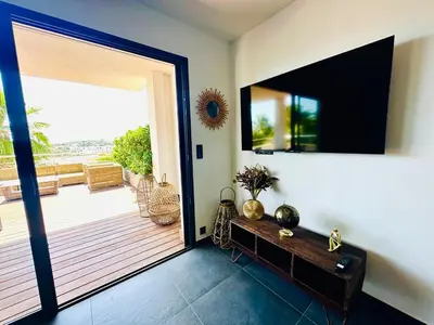 a room with a door open to a deck at Le Deck Porticcio in Grosseto-Prugna