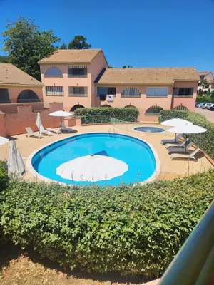 a large swimming pool with umbrellas and chairs at linguizzetta , les marines de bravone in Linguizzetta