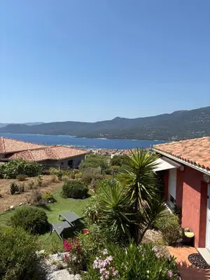 a view of a house with a view of the water at jolie appartement pour 4 personnes à propriano in Propriano