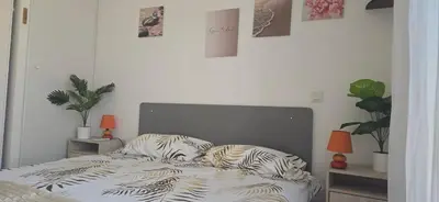 a bedroom with a bed with zebra pillows on it at jolie appartement pour 4 personnes à propriano in Propriano