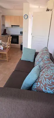 a living room with a couch and a kitchen at jolie appartement pour 4 personnes à propriano in Propriano