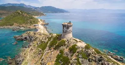 an island with a lighthouse on top of the ocean at Cœur Ajaccio calme plage nature in Ajaccio