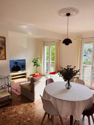 a living room with a table and a couch at Appartement au cœur de Cargèse in Cargèse