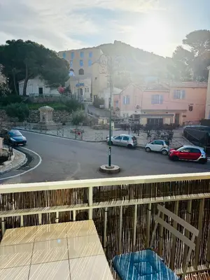 a balcony with a view of a parking lot at Appartement au cœur de Cargèse in Cargèse