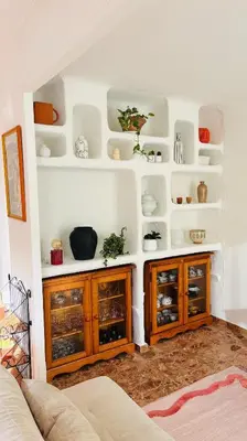 a living room with wooden cabinets and shelves at Appartement au cœur de Cargèse in Cargèse