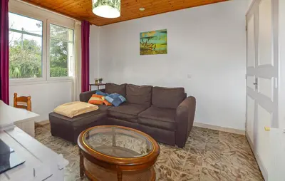 a living room with a couch and a table at Villa Plage À Pieds in Moriani Plage