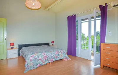 a bedroom with a bed with purple curtains at Villa Plage À Pieds in Moriani Plage