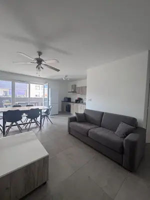 a living room with a couch and a table at Appartement T3 , 6 couchages in Ajaccio