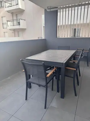 a black table and chairs in a room at Appartement T3 , 6 couchages in Ajaccio
