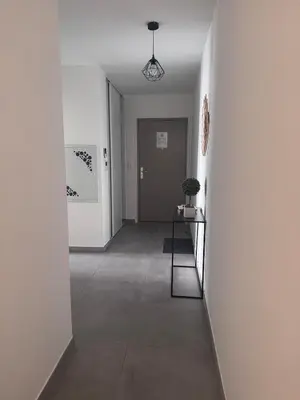 an empty hallway with a table in a room at Appartement T3 , 6 couchages in Ajaccio