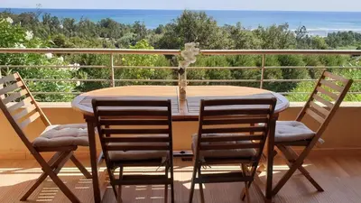 a table and chairs on a balcony with a view of the ocean at SOLENZARA sea view in Sari Solenzara