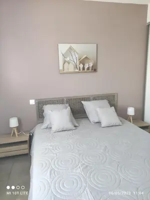 a bedroom with a large bed with two pillows at SOLENZARA sea view in Sari Solenzara