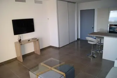 a living room with a flat screen tv on the wall at SOLENZARA sea view in Sari Solenzara