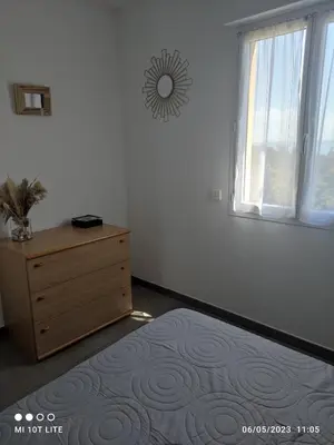 a bedroom with a dresser and a window at SOLENZARA sea view in Sari Solenzara