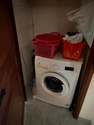 a washing machine with a basket on top of it at Les Oiseaux de Porticcio in Grosseto-Prugna