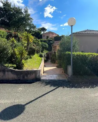 a road with a street light and a house at Les Oiseaux de Porticcio in Grosseto-Prugna