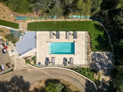 an aerial view of a house with a swimming pool at Cozy Apartment with Pool in Olmeto
