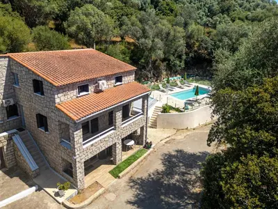 an aerial view of a house with a swimming pool at Cozy Apartment with Pool in Olmeto