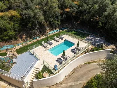 an aerial view of a swimming pool with lounge chairs and a swimming pool at Cozy Apartment with Pool in Olmeto