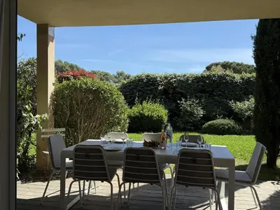 a table and chairs sitting on a patio at T3 Cote Plage n 19 by Pinarello Villa Services in Pinarellu